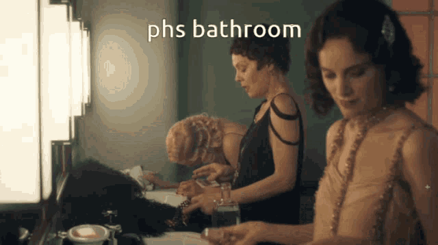 three women in a bathroom with phs bathroom written on the bottom right