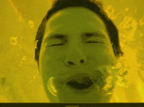 a close up of a person 's face with bubbles coming out of it