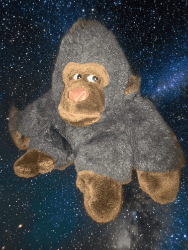 a stuffed gorilla is floating in the air with a starry sky in the background