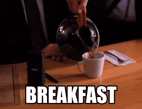 a person pouring coffee into a cup that says breakfast on the table