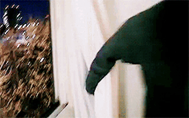 a person is opening a window with a knife