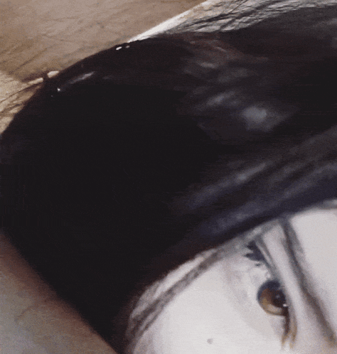 a close up of a person 's face with their hair visible