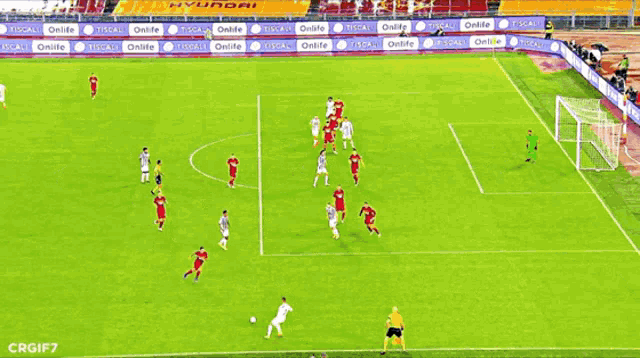 a soccer game is being played on a field with ads for onlife and tiscali