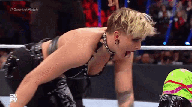 a woman in a wrestling ring with her mouth open