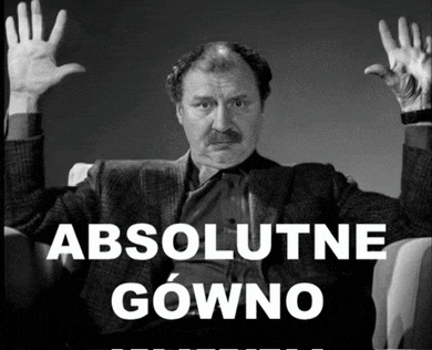 a black and white photo of a man with his hands up and the words absolutne gowno below him