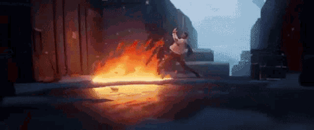 a man is standing in front of a fire .