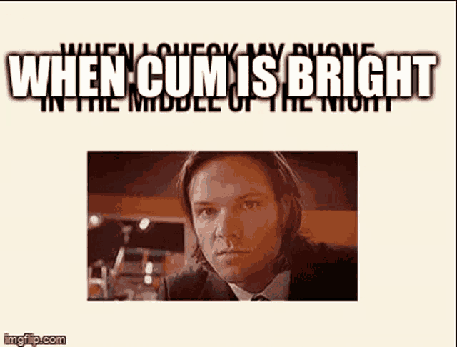 a man in a suit and tie is sticking his tongue out .