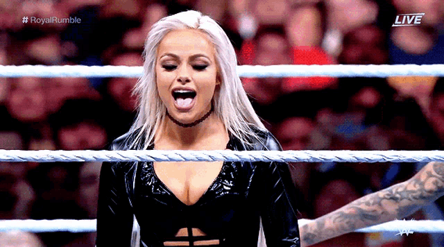 a woman in a wrestling ring with the word live on the bottom right