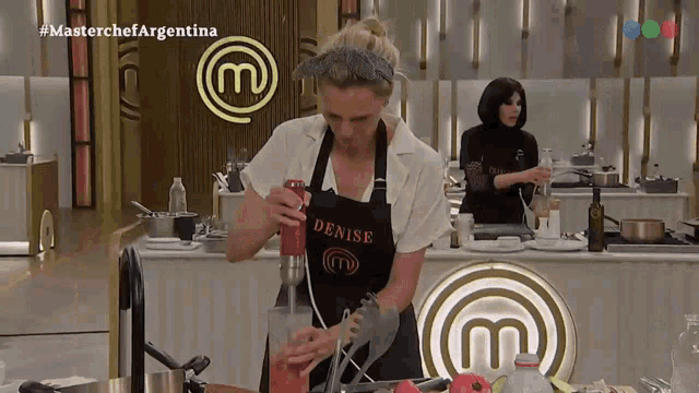 a woman wearing an apron with denise on it
