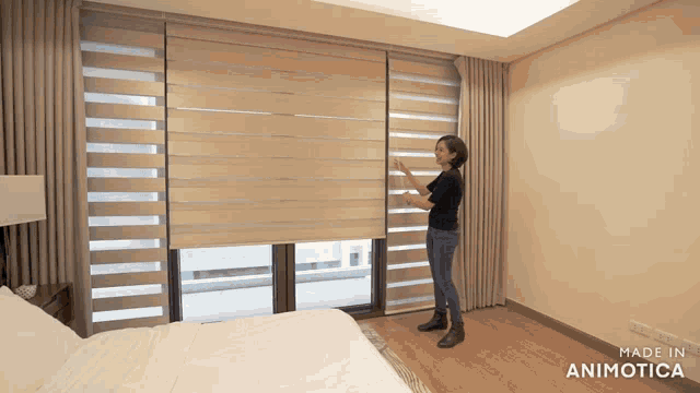 a woman is adjusting a blind in a bedroom made in animonica