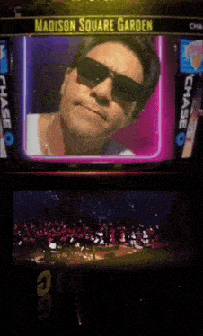 a man wearing sunglasses is on a screen with the words madison square garden on it