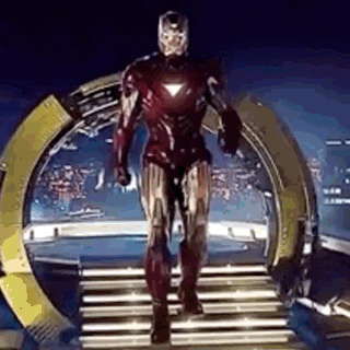 iron man is walking down a set of stairs in a superhero costume .