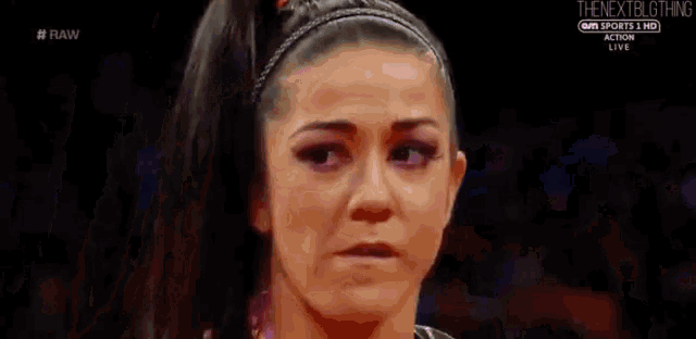 a close up of a woman 's face with a headband on her hair .