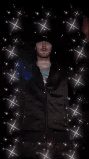 a man wearing a black hat and a black jacket is surrounded by glittering stars