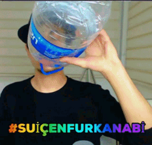 a man is drinking from a plastic bottle with the hashtag #suicenfurkanabi