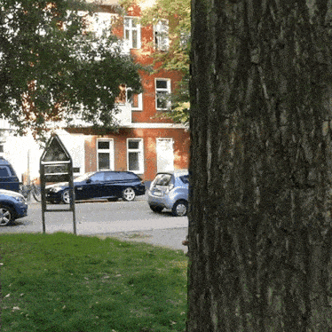 a car parked in front of a building with a license plate that starts with a s
