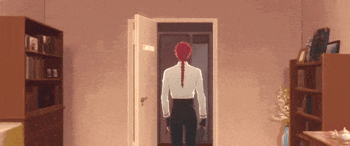 a man with red hair is walking through a door