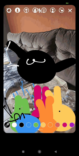 a phone screen shows a drawing of a rabbit with the letter n in the middle