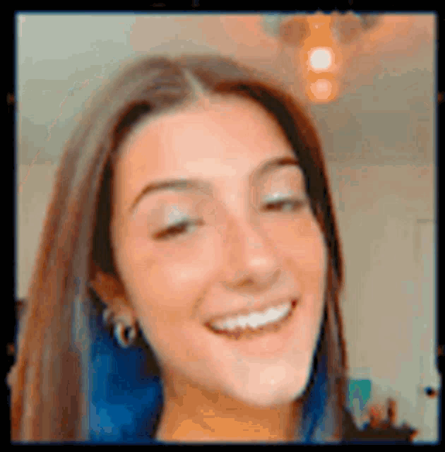 a close up of a woman 's face with a smile on it .