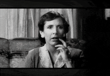 a black and white photo of a woman with a surprised expression on her face