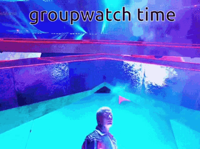 a man stands in front of a stage with the words groupwatch time on the bottom