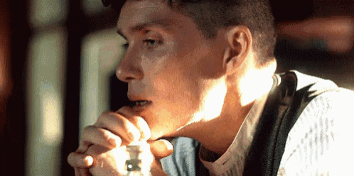 a close up of a man 's face with a light shining on his face