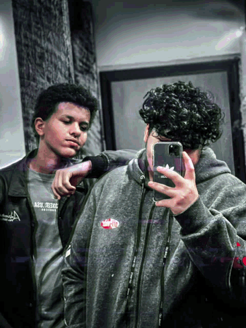 a man taking a picture of himself in a mirror while wearing an ash prince shirt