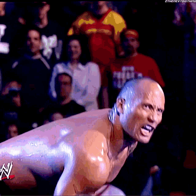 a man in a wrestling match with the word w on the bottom right