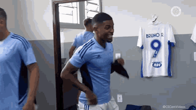 a man in a light blue shirt with the number 9 on it