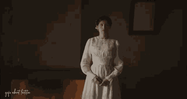 a woman in a white dress is standing in a dark room with the words " gifts about happiness " written on the bottom