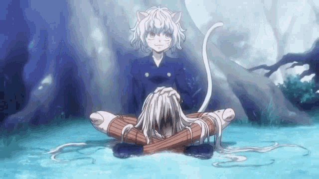 a girl with cat ears is sitting next to a cat in the water .