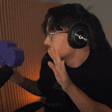 a man wearing headphones and a black shirt that says nabi on it