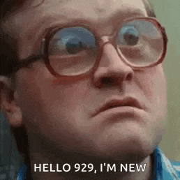 a man wearing glasses and a blue shirt is making a funny face .
