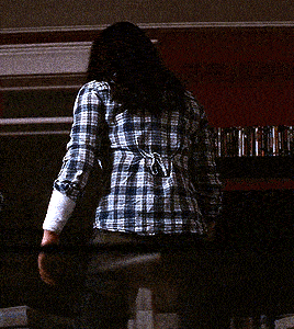 a blurry picture of a person holding a sword in a dark room