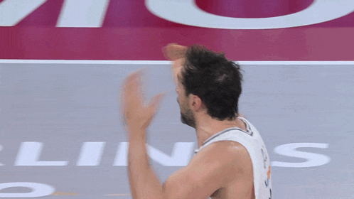 a basketball player throws a ball in front of a sign that says ' lines '