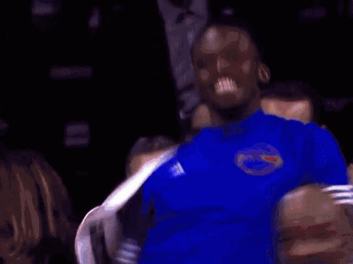 a man wearing a blue shirt with a florida gators logo on it