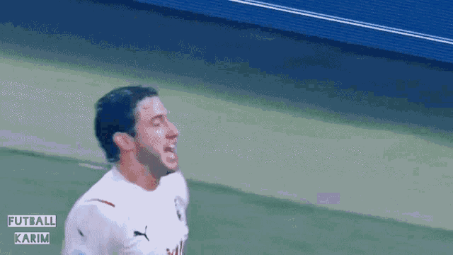 a soccer player is celebrating a goal with the words futball karim on the bottom