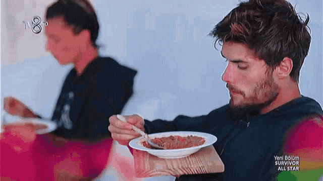 a man is eating a bowl of soup with a spoon and the words survivor all star on the bottom right