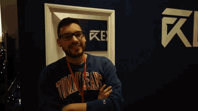 a man wearing a sweatshirt that says tommy jeans
