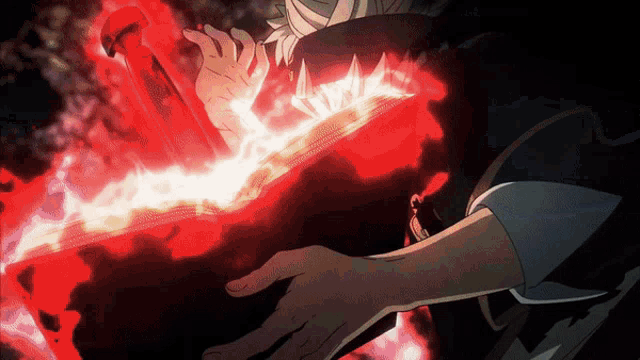 a person is holding a red object that is glowing