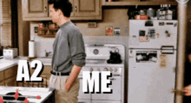 a man standing in a kitchen with a2 me written on the bottom