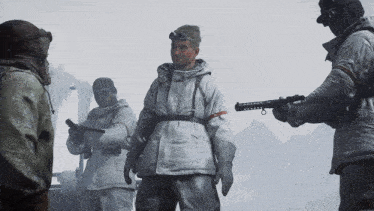 a group of soldiers are standing in the snow and one has a gun