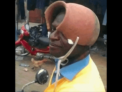 a man wearing a helmet that looks like a clay pot