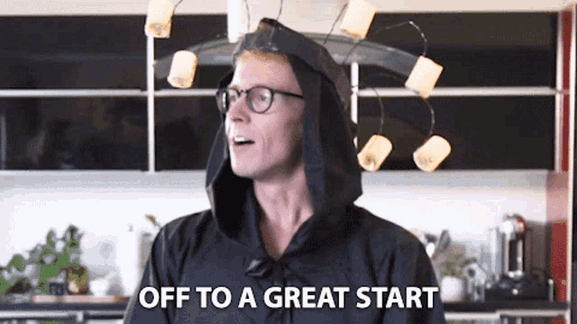 a man wearing a black hooded cape says off to a great start