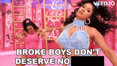 a woman in a blue dress is dancing in front of a sign that says broke boys don t deserve no