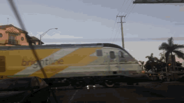 a brightline train is driving down the road