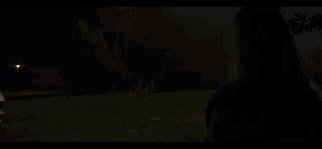 a car is driving down a road at night