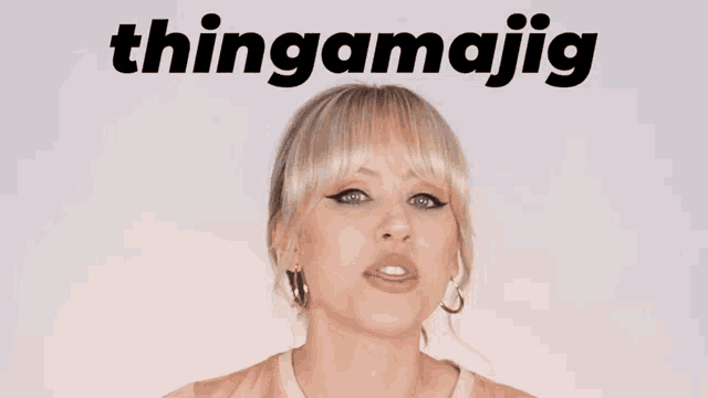 a woman stands in front of a white background that says thingamajig