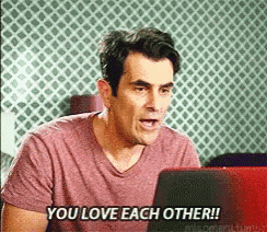 a man sitting in front of a laptop with the words you love each other written on the screen