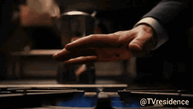 a close up of a person 's hand on a stove with the words @tvresidence below